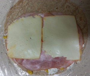 Adding Muenster cheese and mustard to a low carb tortilla wrap