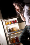 Woman Staring Into Fridge